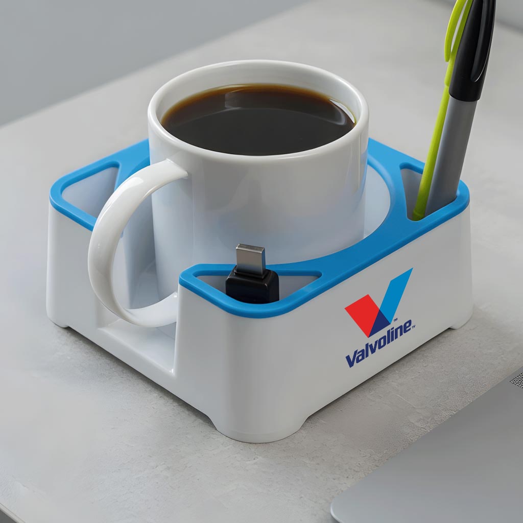 Light MugBrick with a Valvoline logo holding a coffee mug, a USB-C cable, and a pen